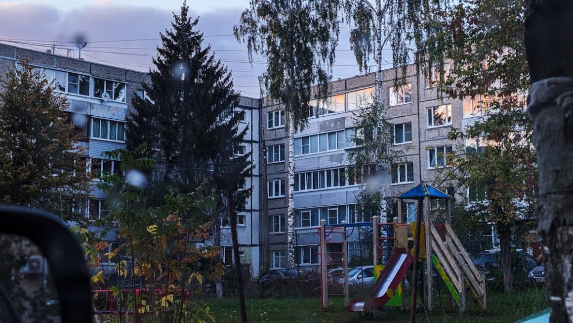 Apartment building with playground in front.