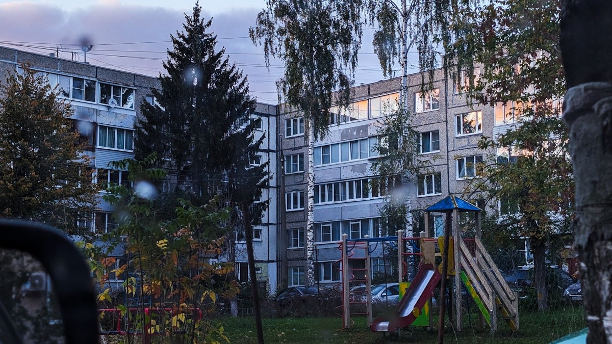 Apartment building with playground in front.